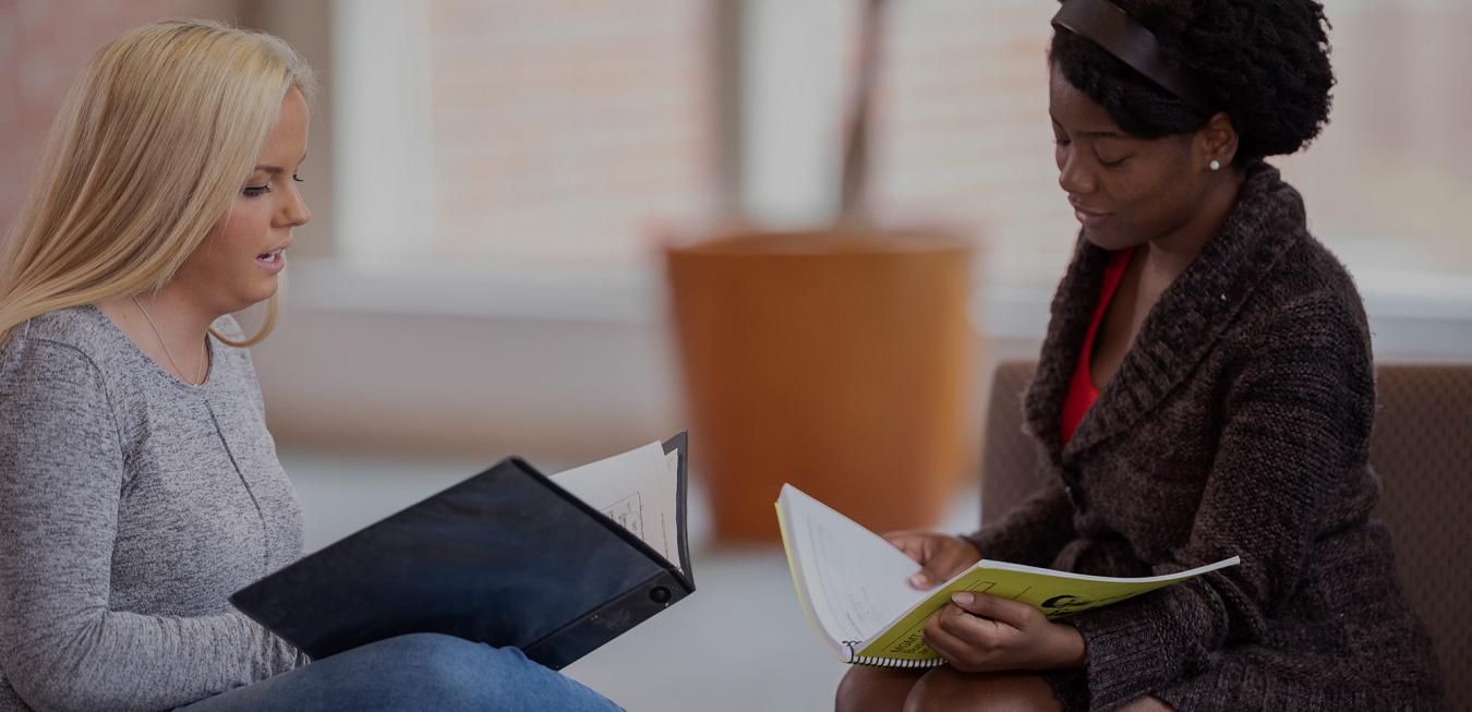 Image: Trulaske students sitting inside Cornell Hall facing each other.