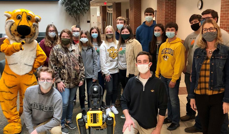 Paris High School students with Truman the Tiger and Spot the Robotic Dog.