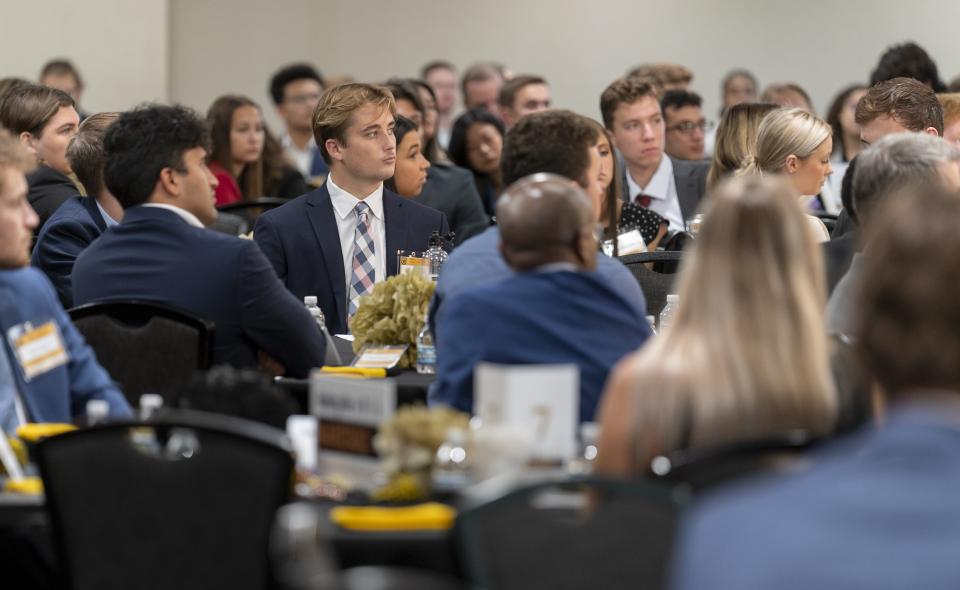 Image: Student focusing at table with other students