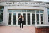 Kaitlyn Berry with her hands on her hips, standing outside of Cornell Hall