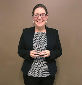 Image: Clarissa Steele holding her award for the Mizzou 3MT competition.